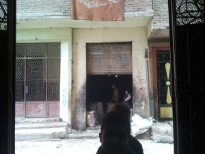 A father and son, presumably, sorting glass across the street from the school